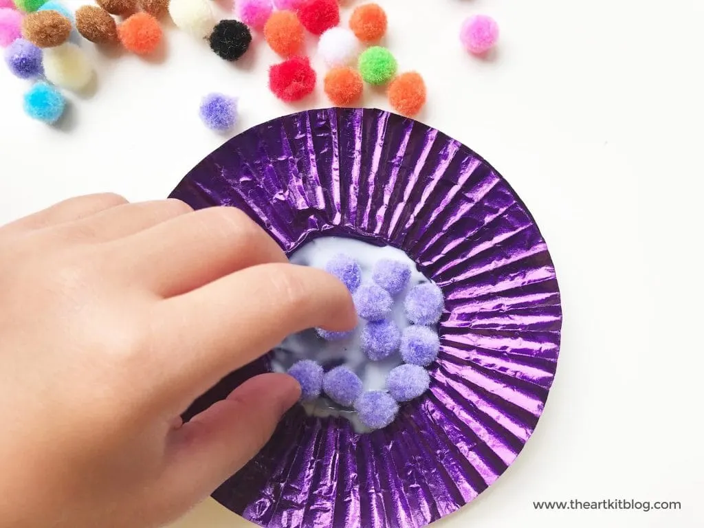 Cupcake liner flower craft easy craft for toddlers preschoolers from the art kit blog